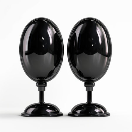 Two elegant black decorative objects stand on a white background, showcasing modern minimalist design and perfect for enhancing any interior space or decor theme.の素材