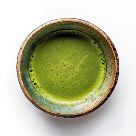 A vibrant bowl of matcha tea, showcasing a rich green hue and delicate foam, perfect for highlighting health, wellness, and culinary artistry in food photography.の素材