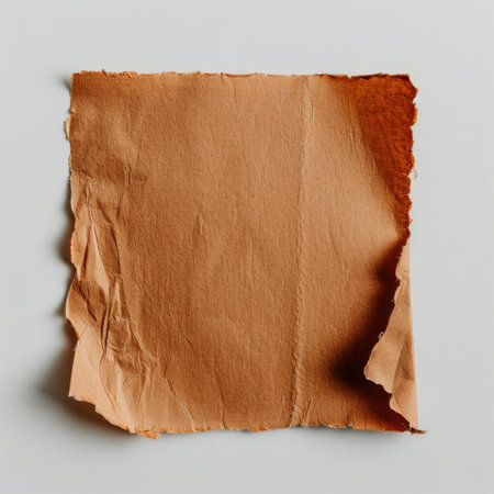 A square piece of textured orange paper featuring torn edges, set against a neutral background. Ideal for artistic projects or creative design purposes.の素材