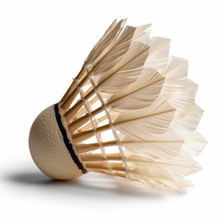 The image showcases a detailed close-up of a shuttlecock, highlighting its unique feathered design against a white background, perfect for sports-related themes.の素材