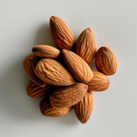 This image showcases raw almonds with rich brown tones and intricate patterns, perfect for highlighting healthy snacking and natural food options in culinary settings.の素材
