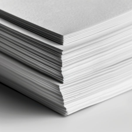 A neatly arranged stack of white paper, perfect for various applications, including printing, writing, or creative projects in an organized workspace.の素材