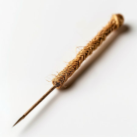 This image showcases a close-up view of an antique needle intricately wrapped in twine. The sharp point and rustic texture highlight its craftsmanship and aesthetic appeal.の素材