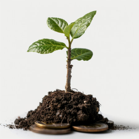 A vibrant green plant emerging from rich soil resting on coins, representing the intersection of financial investment and eco-friendly growth. Ideal for sustainability themes.の素材