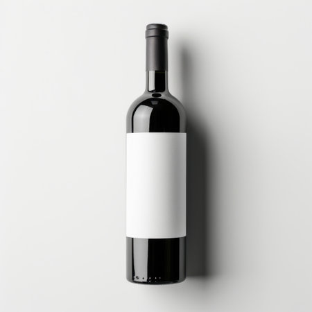 This elegant black wine bottle features a blank label, perfect for customizable branding. Set against a minimalist background, it offers an ideal photographic opportunity.の素材