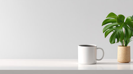A stylish minimalist workspace featuring a white mug and a vibrant green plant on a clean surface, ideal for interior decor and lifestyle inspirations.の素材