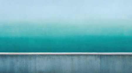 A tranquil abstract image featuring a smooth gradient of soft blue merging into deep green, set against a minimalist concrete wall, perfect for serene design themes.の素材