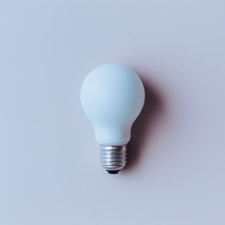 This image features a soft blue light bulb placed on a plain gray background, highlighting its modern design and energy-efficient qualities for stylish interiors.の素材