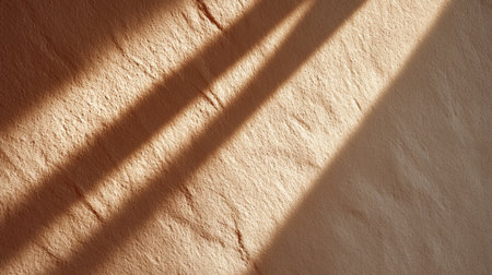 Soft natural light gently illuminates a textured surface, creating delicate shadows and highlighting organic patterns. Perfect for artistic backgrounds or designs.の素材