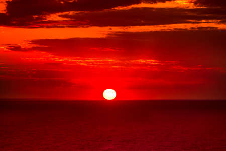 Red dramatic sunset over calm seaの写真素材