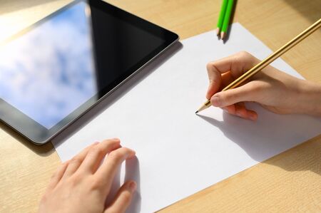 Online lesson at school on a sunny day. Social distance. Learning to draw. Home school conceptの写真素材