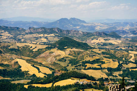 View of the mountains and yellow fields of the Republic of San Marinoの写真素材