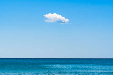 Small cloud over the sea. Horizontal frame. Free space for textの写真素材