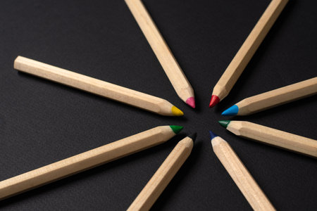 Light pencils on a black background. The pencils are arranged in a circle. Selective focus.の写真素材