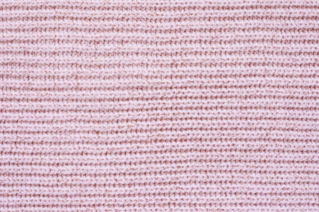 Pink knitted fabric texture. Knitted background with horizontal direction. Focusing in the center of the frameの写真素材