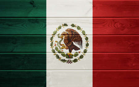 Mexican flag on an old wooden surface.の写真素材
