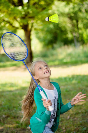 girl on a picnic plays badmintonの写真素材