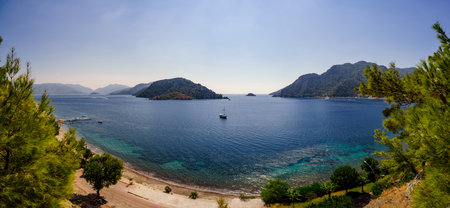 Panoramic view of the sea bay through pine branches. Seascape in the Marmaris area.の写真素材