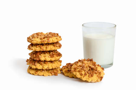Homemade cookies with peanuts and a glass of milk on a white backgroundの写真素材