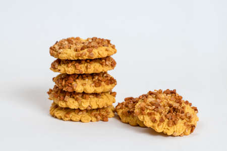 Shortbread cookies with roasted peanuts crumbs on a white backgroundの写真素材