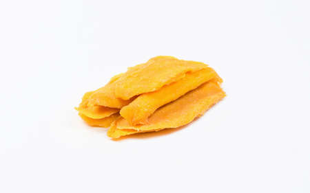 Dried mango slices lie on a white plate. Isolated object.の写真素材