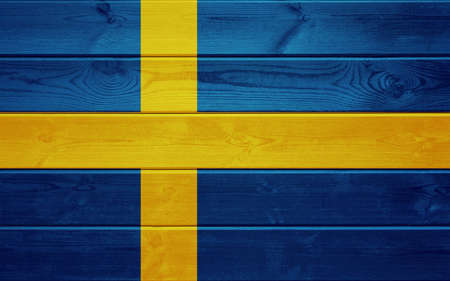Sweden flag on an old wooden surface.の写真素材