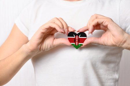 Flag of Kenya in the shape of a heart in the hands of a girl. Love Kenya. The concept of respect for Kenyaの写真素材