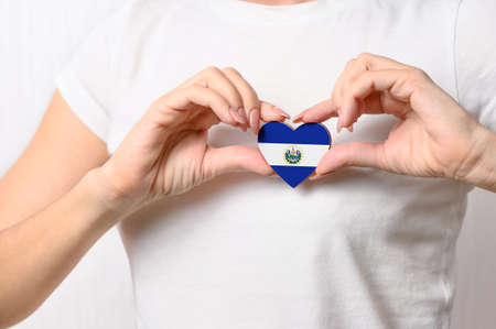 El Salvador flag in the shape of a heart in the hands of a girl. Love Salvador. Patriotism Concept for El Salvadorの写真素材