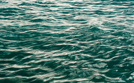 Sea surface with shallow waves. Abstract artistic background on the marine theme. Selective focusing in the center.の写真素材