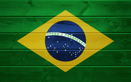 Brazilian flag on old wooden surface.の写真素材
