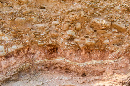 The texture of the cut of the earth. Perennial layers of gravel, red clay and limestone.の写真素材