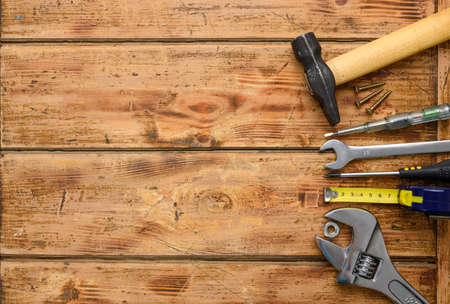 Construction tools on a wooden background. Top view, free white space on the left.の写真素材
