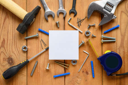 Advertising of construction services. White square sheet and a lot of building tools.の写真素材