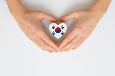 The national flag of South Korea in female hands. The concept of patriotism, respect and solidarity with the citizens of South Korea.の写真素材