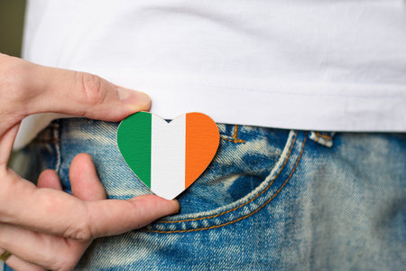 Patriot of the Ireland! Irish flag in the shape of a heart in a man's hand.の写真素材