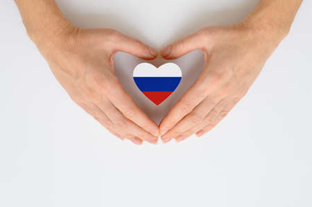 The national flag of Russia in female hands. The concept of patriotism, respect and solidarity with the citizens of Russia.の写真素材