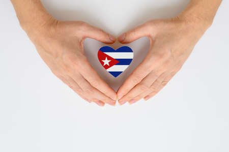 The national flag of Cuba in female hands. The concept of patriotism, respect and solidarity with the citizens of Cuba.の写真素材