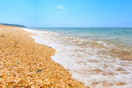 Wild beach on the Black Sea in Crimea on the territory of the reserve. Selective focus in the center of the frame.の写真素材