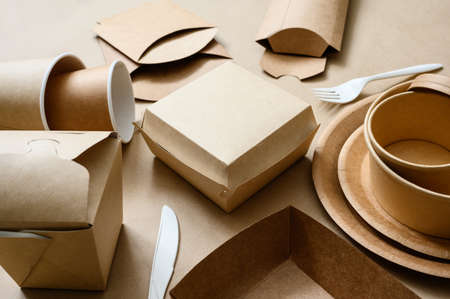 Disposable biodegradable tableware made of cardboard and paper. Ecology concept. Selective focus in the center of the frame.の写真素材