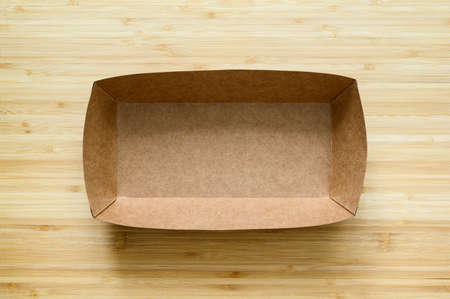 Empty cardboard box for food on a wooden background. view from above. copyspace.の写真素材
