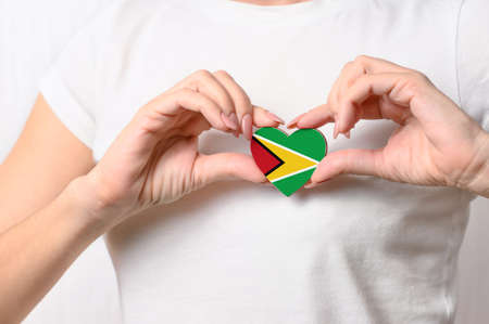 Flag of Guyana in the shape of a heart in the hands of a girl. Love Guyana. Respect for the people of Guyanaの写真素材