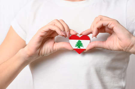 Flag of Lebanon in the shape of a heart in the hands of a girl. Love and respect Lebanon.の写真素材