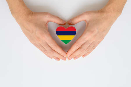 The national flag of Mauritius in female hands.の写真素材