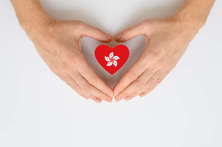 The national flag of Hong Kong in female hands.の写真素材