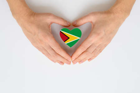 The national flag of Guyana in female hands.の写真素材