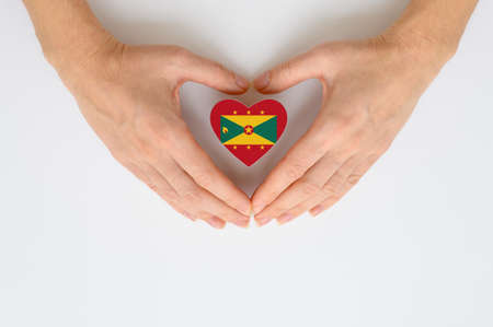 The national flag of Grenada in female hands.の写真素材