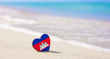 Flag of Cambodia in the shape of a heart on a sandy beach. The concept of the best vacation in Cambodia resortsの写真素材