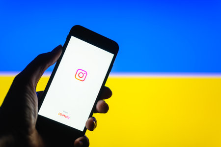 Vladimir, Russia - April 2022: The operation of the Instagram social network in Ukraine. Instagram application on the background of the national flag of Ukraine. Selective focus on the logo.のeditorial素材
