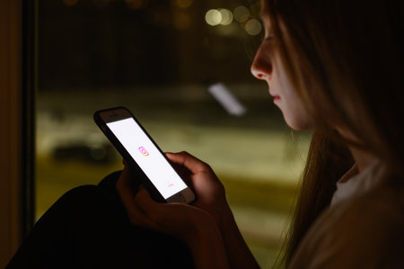 Vladimir, Russia - January 2022: Instagram social network application on a smartphone in a girl's hand. Selective focus on the logo.のeditorial素材