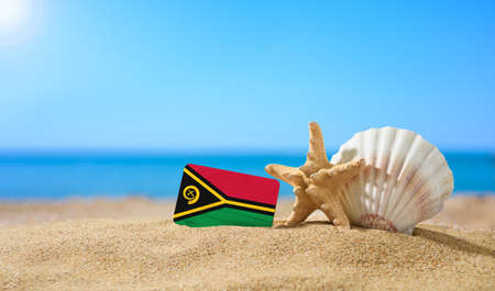 Tropical beach with seashells and Vanuatu flag. The concept of a paradise vacation on the beaches of Vanuatu.の写真素材